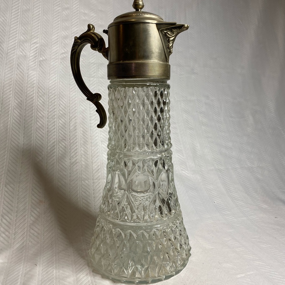 Antique pitcher cut crystal with silver plate top.